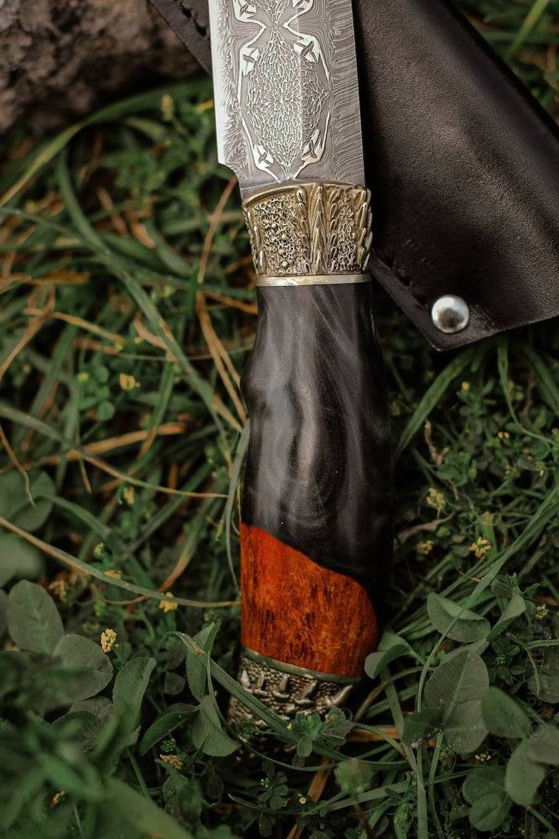 Damascus steel hunting knife featuring dragon head design